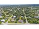 An aerial view showcasing a single-Gathering house with a pool, situated in a quiet neighborhood at 791 Haleybury St, Port Charlotte, FL 33948
