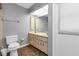 Bathroom with double vanity, toilet and access to the pool area at 791 Haleybury St, Port Charlotte, FL 33948