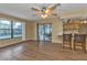 Living room with wood-look floors, ceiling fan, and view of patio at 791 Haleybury St, Port Charlotte, FL 33948