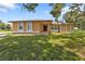 Single-story house with a large front yard and driveway at 791 Haleybury St, Port Charlotte, FL 33948