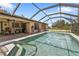 Inviting screened pool area with patio furniture, ready for relaxation at 791 Haleybury St, Port Charlotte, FL 33948