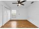 Spacious bedroom with wood-look floors, ceiling fan, and double closets at 791 Haleybury St, Port Charlotte, FL 33948