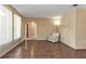 Living room with wood-look floors and an adjoining room at 791 Haleybury St, Port Charlotte, FL 33948