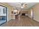 Living room with fireplace, wood-look floors, and kitchen bar at 791 Haleybury St, Port Charlotte, FL 33948