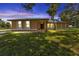 Single story home with light yellow exterior, front yard, and driveway at 791 Haleybury St, Port Charlotte, FL 33948