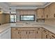 Kitchen with double sink and wood cabinets at 791 Haleybury St, Port Charlotte, FL 33948