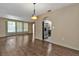 Dining room with wood-look floors and view into kitchen at 791 Haleybury St, Port Charlotte, FL 33948