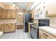 Light wood cabinets, black appliances, and tile floor kitchen at 791 Haleybury St, Port Charlotte, FL 33948