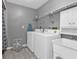 Laundry room complete with washer, dryer, shelving, and utility sink at 791 Haleybury St, Port Charlotte, FL 33948