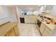 Galley kitchen with light countertops and appliances at 3600 Bal Harbor Blvd # 1-O, Punta Gorda, FL 33950