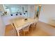 Dining area with tile-top table and six chairs, open to kitchen at 3600 Bal Harbor Blvd # 1-O, Punta Gorda, FL 33950