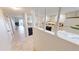 Kitchen with white cabinets and view to living room at 3600 Bal Harbor Blvd # 1-O, Punta Gorda, FL 33950