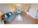Spacious living room with teal sofas and water views at 3600 Bal Harbor Blvd # 1-O, Punta Gorda, FL 33950
