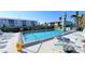 Community pool with surrounding patio furniture at 3600 Bal Harbor Blvd # 1-O, Punta Gorda, FL 33950