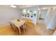 Bright dining area with tile-top table and six chairs, open to kitchen at 3600 Bal Harbor Blvd # 1-O, Punta Gorda, FL 33950