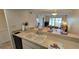 Bright kitchen features double sink, dishwasher, and view into dining area at 3600 Bal Harbor Blvd # 1-O, Punta Gorda, FL 33950