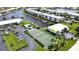 Aerial view of waterfront community with tennis courts, pool, and boat slips at 3600 Bal Harbor Blvd # 1-O, Punta Gorda, FL 33950
