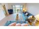 Relaxing living room with teal sofas and balcony access at 3600 Bal Harbor Blvd # 1-O, Punta Gorda, FL 33950