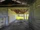 Interior of a barn with dirt floor, stalls, and exposed beams at 31840 Washington Loop Rd, Punta Gorda, FL 33982