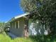 Brick building with damaged windows and overgrown landscaping at 31840 Washington Loop Rd, Punta Gorda, FL 33982