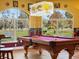 Pool table in a game room with large windows overlooking the backyard at 32121 Washington Loop Rd, Punta Gorda, FL 33982