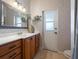 Bathroom with wood cabinets, patterned wallpaper, and a walk-in shower at 32121 Washington Loop Rd, Punta Gorda, FL 33982