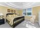 Bright main bedroom with king-size bed, large window, and a dresser at 3311 Wood Thrush Dr # 113, Punta Gorda, FL 33950