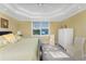 Comfortable main bedroom with king-size bed, window, and built-in wardrobe at 3311 Wood Thrush Dr # 113, Punta Gorda, FL 33950