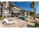 Community pool with lounge chairs and tropical landscaping at 3311 Wood Thrush Dr # 113, Punta Gorda, FL 33950