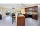 Open concept kitchen with island, stainless steel appliances, and view to living room at 3311 Wood Thrush Dr # 113, Punta Gorda, FL 33950