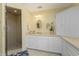 Clean bathroom with a single vanity, walk-in shower, and corner cabinet at 3311 Wood Thrush Dr # 113, Punta Gorda, FL 33950