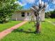 House exterior showcasing walkway and landscaping at 21440 Holdern Ave, Port Charlotte, FL 33952