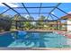 Inviting screened pool area with patio and lush landscaping at 25499 Taltal Dr, Punta Gorda, FL 33983