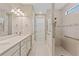 Elegant bathroom with double vanity and walk-in shower at 1596 Hyssop Loop, North Port, FL 34289