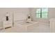 Bright bedroom with a queen-size bed and ample natural light at 1596 Hyssop Loop, North Port, FL 34289