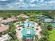 Community pool with surrounding lounge chairs and palm trees at 1596 Hyssop Loop, North Port, FL 34289