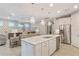 Modern kitchen with white cabinets, quartz countertops, and stainless steel appliances at 1596 Hyssop Loop, North Port, FL 34289