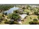 Stunning aerial view of bright yellow home with lake access and lush green landscaping at 24395 Suncoast Blvd, Punta Gorda, FL 33980