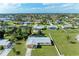 A residential neighborhood featuring manicured lawns and in-ground pools surrounded by lush landscaping at 258 Shadow Nw St, Port Charlotte, FL 33952
