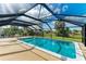 A stunning in-ground pool is enclosed within a screened-in lanai, offering privacy and protection from the elements at 258 Shadow Nw St, Port Charlotte, FL 33952