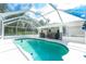 A beautiful screened pool with an attached covered patio sitting area, perfect for relaxing and entertaining at 3159 Draper Ter, North Port, FL 34286