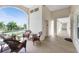 Covered balcony with wicker furniture and view of tennis courts at 1250 W Marion Ave # 242, Punta Gorda, FL 33950