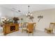 Bright dining room with glass-top table and wood cabinetry at 1250 W Marion Ave # 242, Punta Gorda, FL 33950