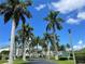 Luxury condo building with palm trees and landscaping at 1250 W Marion Ave # 242, Punta Gorda, FL 33950