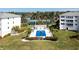 Community pool and tennis courts, lush landscaping at 1250 W Marion Ave # 242, Punta Gorda, FL 33950