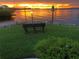 Scenic waterfront view at sunset with a bench at 1250 W Marion Ave # 242, Punta Gorda, FL 33950