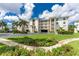 Building exterior showcasing landscaping and parking at 1250 W Marion Ave # 242, Punta Gorda, FL 33950