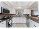 Modern kitchen with stainless steel appliances and granite countertops at 1250 W Marion Ave # 242, Punta Gorda, FL 33950
