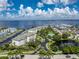 Aerial view of waterfront community with tennis courts, pool, and boat docks at 1250 W Marion Ave # 242, Punta Gorda, FL 33950