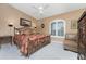King-size bed, window seating, and a ceiling fan in the main bedroom at 1250 W Marion Ave # 242, Punta Gorda, FL 33950